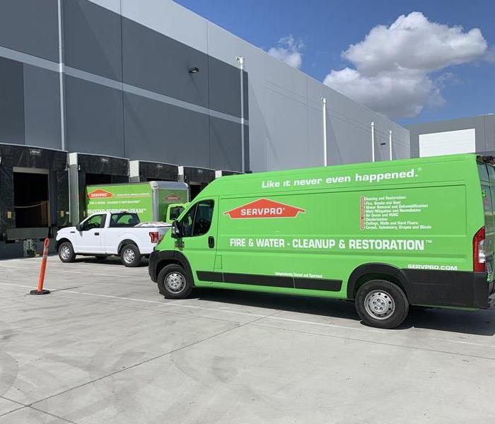 Servpro trucks outside of a warehouse