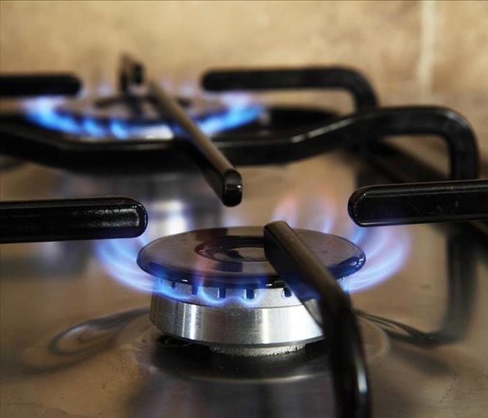 Gas stove with two burners that are lit