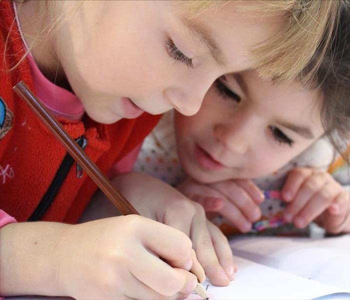 two kids drawing together